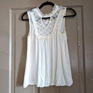 Sheer white sleeveless blouse with lace insets
